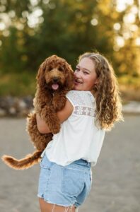 Lila held in a young woman's arms outdoors