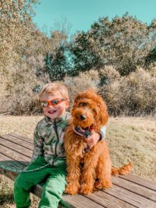 Geneva sitting beside a boy on a picnic bench